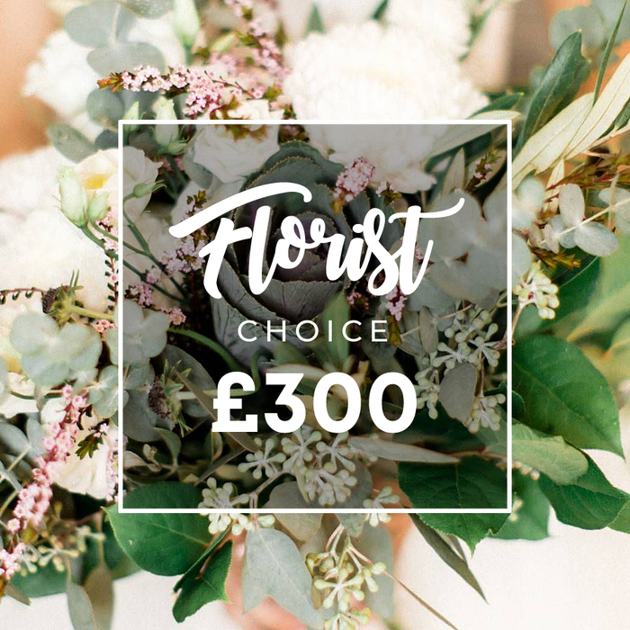 Set against Oxford's sunlit streets, this Florist Choice bouquet radiates ceremonial grace. The dominant creamy white blooms-garden roses, peonies, or chrysanthemums-are artfully arranged with smaller white lisianthus or campanula, and interwoven with pale pink mauve fillers. The greenery is abundant: rounded eucalyptus, slender olive branches, and clusters of tiny pale green berries that suggest fresh growth. In the center sits a darker green, almost purplish ornamental kale or a unique succulent head, offering a modern, sculptural point of focus. A white frame bearing Florist Choice floats above the arrangement, with Florist in flowing script, CHOICE in uppercase beneath, and the price ?300 displayed proudly. The background softens to peach and cream, ensuring the bouquet commands attention in Oxford's windows and on local delivery routes.

Designed with occasions in mind, this bouquet is ideal for graduations, anniversaries or a heartfelt congratulations. Its refined balance of bold, statement blooms and delicate filler creates a versatile gift that suits halls of residence near Jericho, residential streets around Headington, or a doorstep on Oxford's University Parks side. The piece speaks of expert curation and dependable freshness, available for delivery across the city, often the same day, ensuring that the moment is captured while the flowers are at their peak.

With its elegant composition and contemporary edge, this Florist Choice arrangement carries a sense of celebration and warmth, a thoughtful gesture to mark a milestone or to lift spirits in a busy city. It's the sort of bouquet you picture arriving in a crisp box on a doorstep near the river Isis, ready to brighten a room and a day.