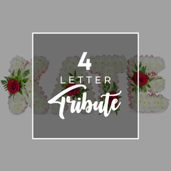The image presents a poised and contemplative scene built around a four-letter floral tribute, the kind a family in Oxford might choose for a funeral at a local chapel or crematorium. Dominating the centre is a dark grey square, softly see-through, edged with a clean white line that gives it a framed, contemporary feel. Across this panel, the inscription "4 LETTER" appears in confident white capitals, while beneath, the word "Tribute" is written in graceful script, suggesting something personal and lovingly made. Behind this panel, only partially revealed like a quiet memory, is a series of four flower-filled letters. They are composed of closely clustered white chrysanthemums, each petal finely ruffled, building up a thick, cushiony surface that seems almost velvety to the touch. Around the sides, a narrow edging of pale pink ribbon or fabric peeks through, giving each letter a soft blush outline, much like the gentle tones often requested by families around Botley, Cowley, or Marston. Interspersed among the white blooms are carefully placed red roses, their deep crimson heads surrounded by lush green foliage. The roses' rich colour and layered petals provide a striking emotional counterpoint, symbolising enduring love, while the greenery adds life and movement, echoing the natural calm of Oxford's parks and riverside walks. Outside the central frame, the background remains a simple, even light grey, ensuring no detail competes with the tribute itself. The composition as a whole illustrates the idea of custom word and name tributes-perhaps for a first name, a familial nickname, or a tender word of farewell-crafted with the care and sensitivity that funeral flowers demand.