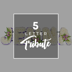A carefully composed photograph presents a bespoke five-letter funeral tribute resting on a smooth, pale grey surface, the muted background allowing the floral craftsmanship to stand out. Each letter is formed from dozens of fresh white chrysanthemums, their petals densely layered so that the faces of the letters appear soft, cushioned, and almost velvety to the touch. A border of rich purple satin ribbon runs neatly around every edge, its subtle sheen catching the light and lending a respectful, regal tone that suits a final goodbye. At selected corners and along the curves of the letters, the base of white blooms is interrupted by delicate clusters of pale pink and lilac spray roses, interwoven with bright green ferns and small leaves that seem to fan gently outward. These accents bring depth and gentle colour without diminishing the sense of calm. The arrangement appears to spell out a name - with a clearly defined "J" to the left, followed by "O," "H," and "N" partially visible, and an "A" on the right - suggesting a personalised tribute like those often ordered for services in Oxford's churches or crematorium chapels near Botley, Cowley, or Marston. A translucent grey square overlay, framed by a bold white outline at the centre of the image, carries the words "5 LETTER Tribute" in bright white text, the top line in a modern uppercase font and the word "Tribute" in an elegant script, clearly explaining the style on offer. The photograph conveys quiet dignity, the sort of name arrangement a local family might request for a remembrance gathering, created with the steady, practiced hands of a florist who often supports farewells across Oxford.