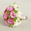 Laid gently on a pale, finely woven fabric, this bridal bouquet feels like a serene moment captured between vows and celebration in Oxford's city centre. Full, velvety pink roses dominate the left and middle of the arrangement, their layered petals shifting from a soft, powdery blush deep inside to a vibrant magenta rim, as though brushed by evening light over the rooftops near the High Street. Tucked between the roses, bright lime green button chrysanthemums form small, rounded clusters, their bumpy texture adding interest and their fresh colour recalling new leaves along the River Thames by Folly Bridge. On the right side, a cascade of white lisianthus blossoms and buds spills outward, their ruffled, paper-fine petals in shades of creamy and pure white creating a gentle, floating effect around the bolder hues. The stems are bound together into a tidy handle, wrapped in smooth blush satin ribbon that feels soft and luxurious to the touch. Encircling the ribbon, delicate strands of white pearls are coiled with care, catching hints of light like reflections in the windows of Oxford's historic chapels. The bouquet rests against a neutral linen-like background with a subtle crosshatch texture, allowing the pinks, greens, and whites to stand out in quiet harmony. Crafted with the sensitivity of an experienced local florist, this bouquet suggests romance, intimacy, and thoughtful detail, ideal for a wedding near Oxford's dreaming spires or for any special celebration that calls for refined beauty and heartfelt emotion.
