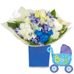 A celebratory, lullaby-soft bouquet arranged in a deep royal-blue gift box, paired with a playful baby carriage foil balloon that reads It's a Boy. At the heart of the arrangement, creamy white roses cluster with elegant white lilies-some just opening-whose faint, honeyed scent seems to fill the air and speaks of new beginnings. Full, cushiony white chrysanthemums form a soft base, their texture like feathered cushions against the hand, while bold electric-blue chrysanthemums punctuate the composition with joyful contrast. Scattered through the mass are small lavender-periwinkle blooms, reminiscent of hyacinths, their clustered stars adding delicate texture and a whisper of spring. Fresh green foliage, broad glossy leaves and fern fronds, fans out around the flowers, giving the bouquet a natural, garden-fresh depth that catches the light. The stems are gathered in crinkled, translucent cream tissue that rustles quietly when moved, and the whole is anchored in a sturdy matte royal-blue rectangular box that feels like a thoughtful gift rather than a simple vase. To the right, a light-blue foil pram-shaped balloon floats slightly above the box, decorated with darker blue canopy and wheel accents, tiny polka dots and hearts, and cheerful yellow-green lettering that announces the arrival. The overall mood is bright, tender and celebratory-perfect for a hospital visit, a new-mum doorstep surprise, or a baby shower in and around Oxford's leafy streets. This arrangement reads as a careful, handcrafted welcome for a newborn son, combining classic whites and bold boy-blue highlights with the quiet scent and texture of freshly cut florals.