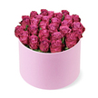 A luxurious cluster of deep fuchsia and magenta roses spills from a round, pastel pink hat box, set crisply against a bright white background that makes every petal glow. The cylindrical box has a smooth, suede-like matte texture, its soft blush tone providing a gentle contrast to the intense, jewel-like colours of the blooms above. Seen from just above eye level, the roses form a flawless dome, packed so tightly together that the arrangement resembles a plush, floral cushion, with no visible gaps between the flower heads. Each rose shows a graceful spiral of petals, beginning with lighter pink at the centre and deepening into richer, berry and plum hues along the edges, where delicate shadows add dimension and depth. Only a suggestion of dark green foliage peeks through, carefully tucked in so it supports the design without drawing attention away from the vibrant blossoms. The composition is clean and contemporary, echoing the style you might expect from a boutique florist delivering across Oxford's city centre, Jericho, or the leafy streets of Summertown. You can almost imagine this box of roses resting on a polished dining table before a dinner party, or on a windowsill overlooking Oxford's spires, filling the room with a soft, romantic fragrance. The image captures a sense of thoughtful extravagance - a perfect floral hat box for Valentine's Day, an anniversary along the River Thames, or a special congratulations sent to a new graduate celebrating near the colleges.